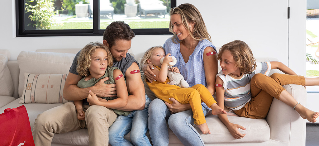 Family sitting displaying flu shots
